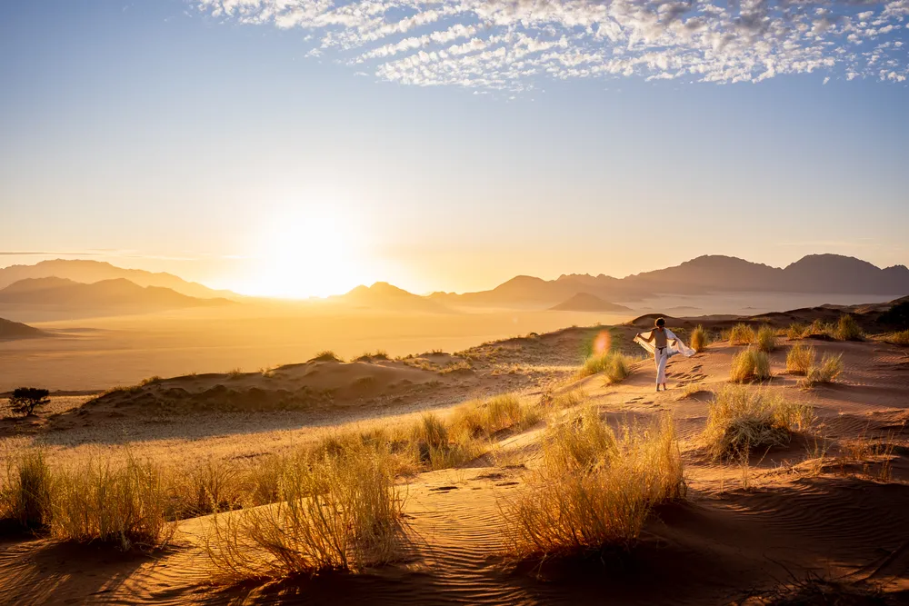 Woman walking in the desert dunes